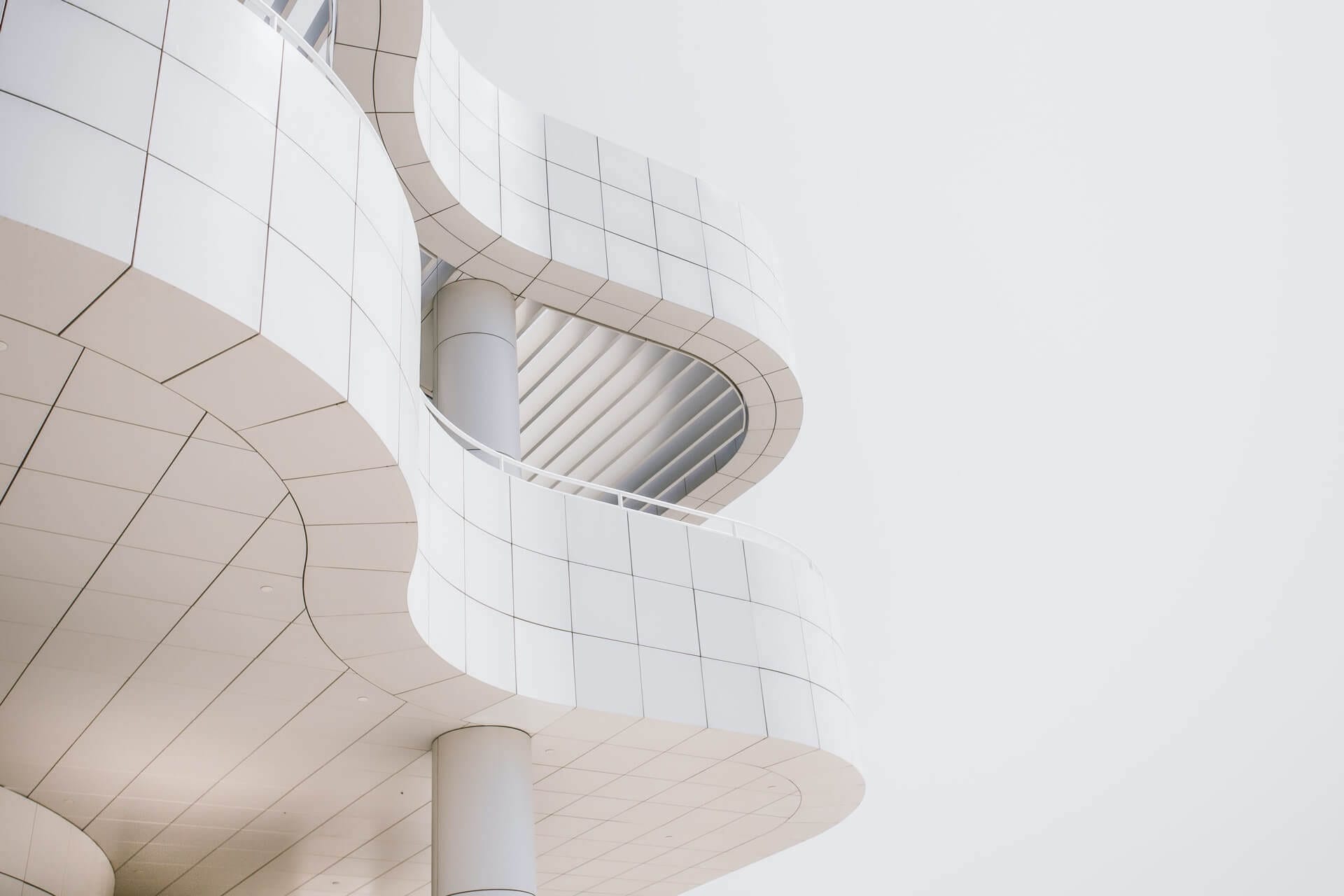 Modern white architectural building with curved design.