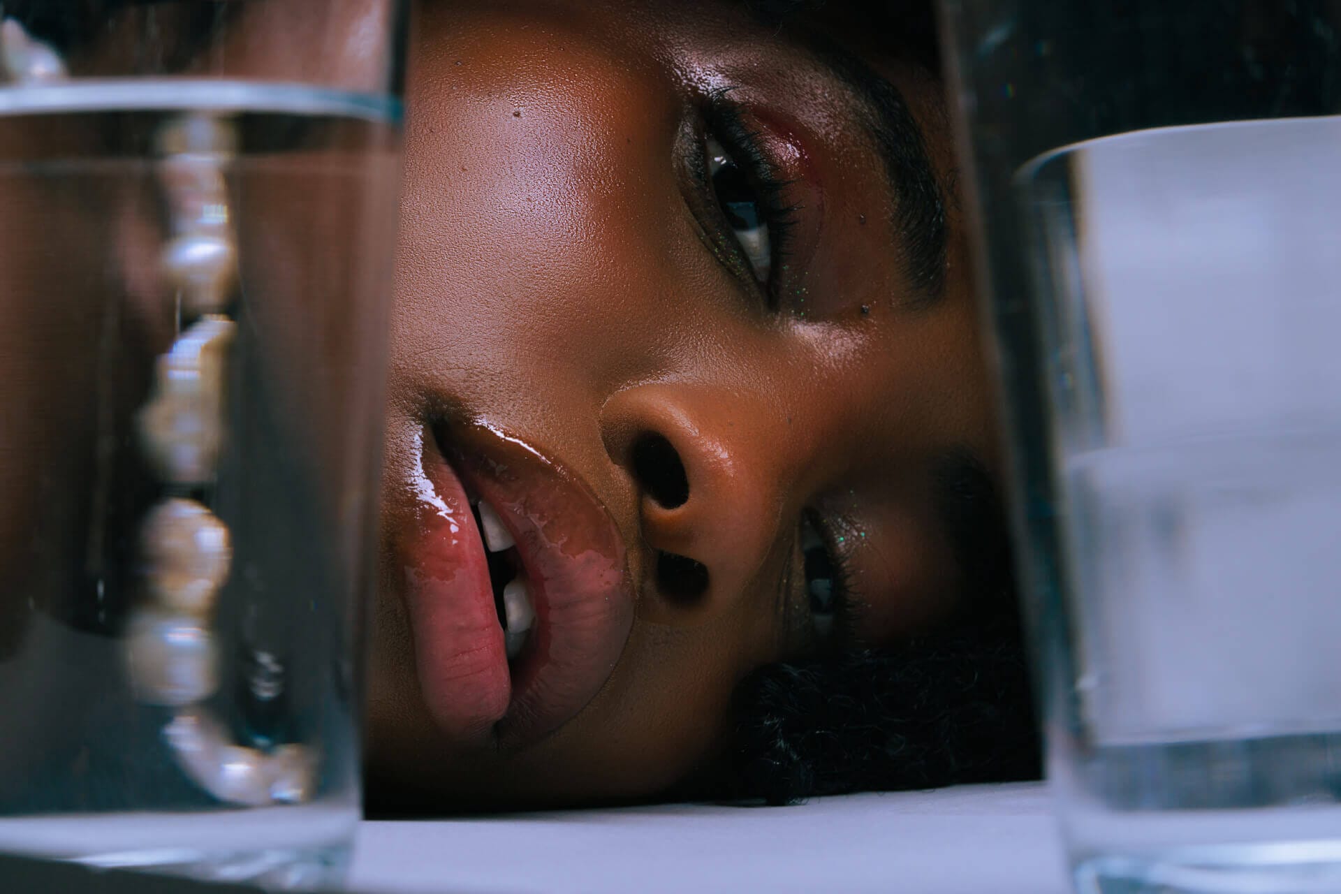 Close-up of a woman's face through glass.