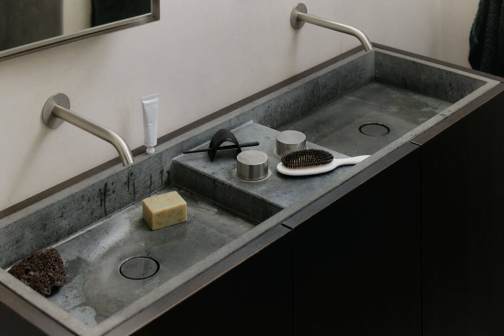 Gray double sink with grooming items.