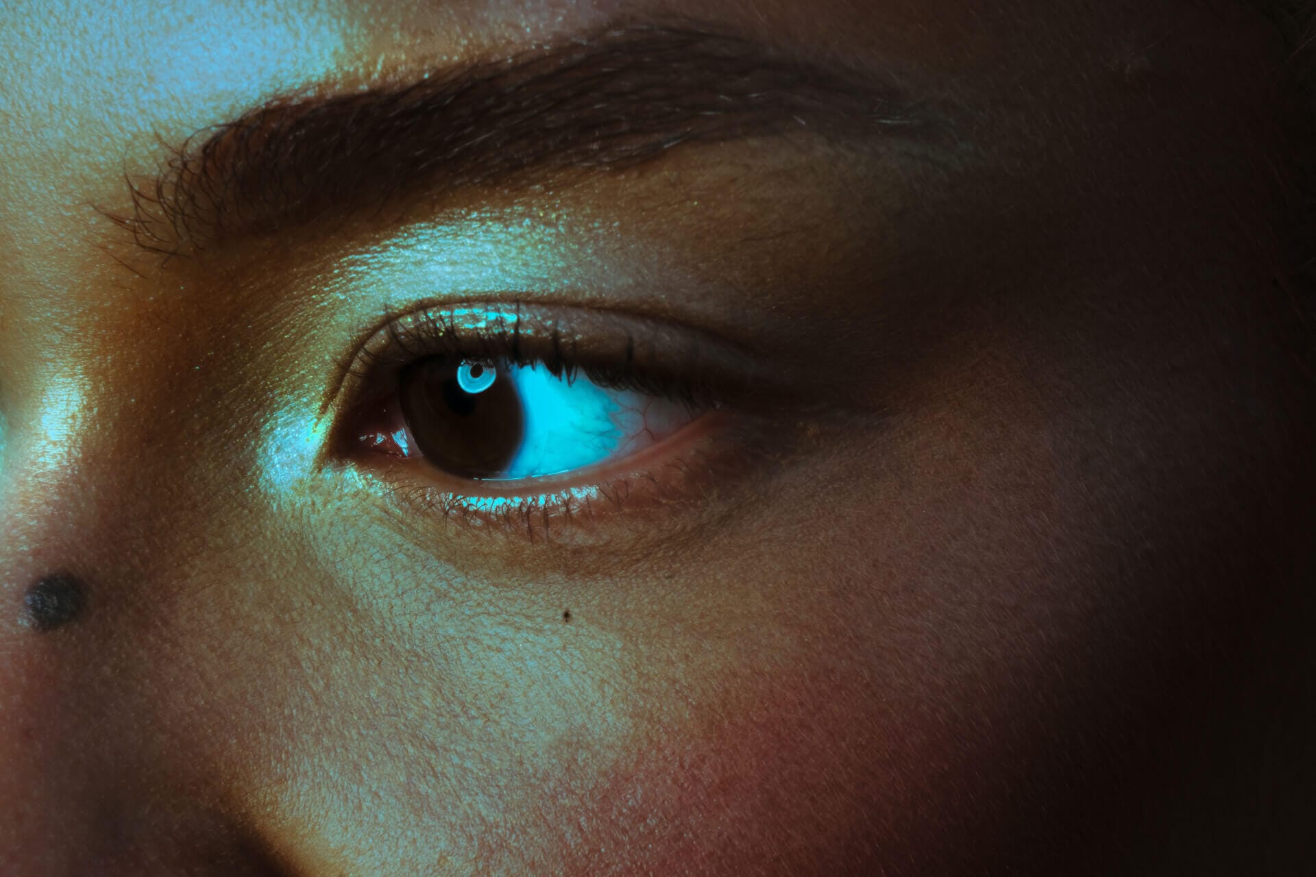 Close-up of eye with dramatic lighting.