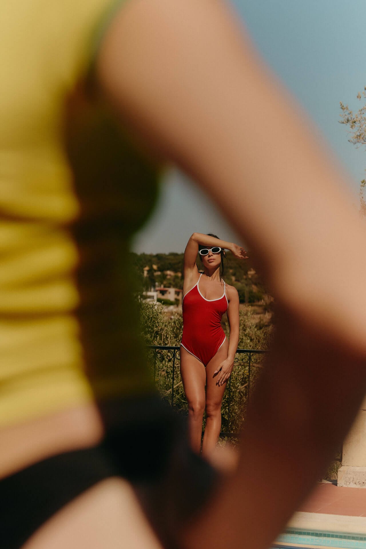 Person in red swimsuit by the pool.