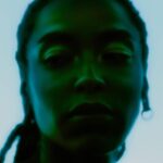 Mysterious silhouette of a person, green hues.