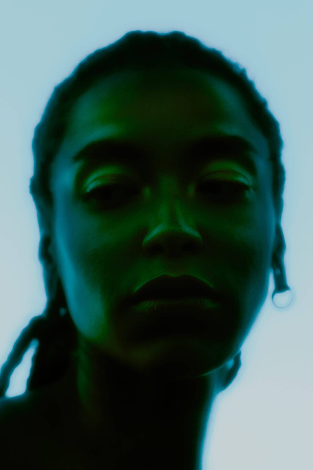 Mysterious silhouette of a person, green hues.