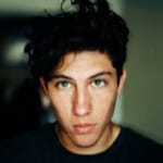 Young man with dark hair, serious expression.