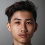 Young person with short hair, neutral expression.